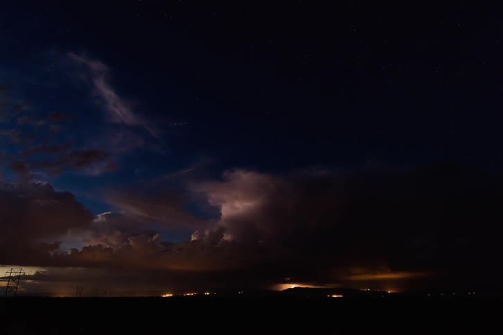 Lightning is flashing in the dawn sky as it turns to night