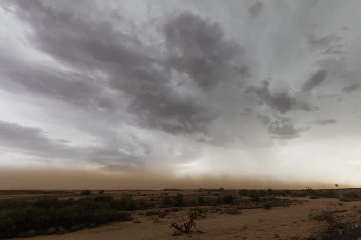 A sand storm moves over the desert