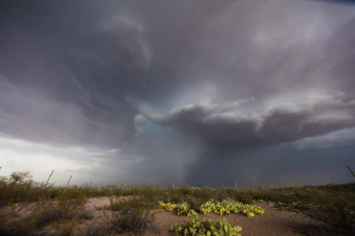 The clouds spin and give off lightning and rain ahead