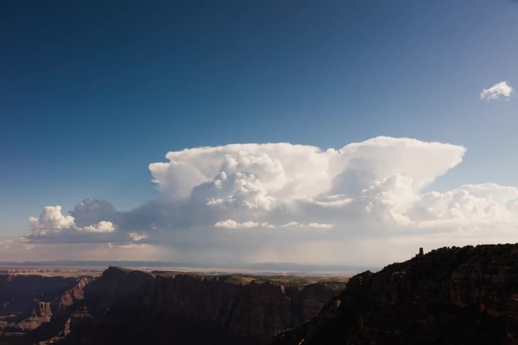Clouds rolling over plateaus on a sunny day