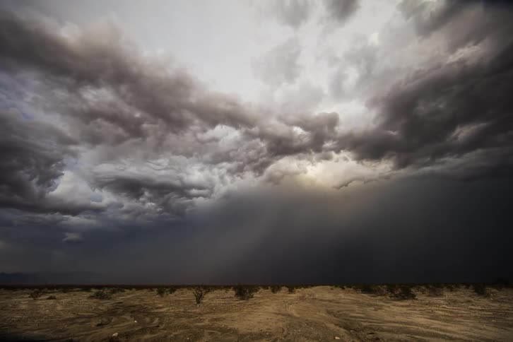 Clouds and lightning roll over plains