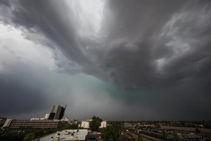 A huge rain cloud is moving over a city