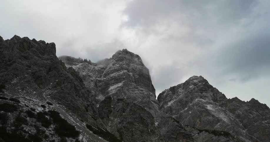 The clouds move slowly over the mountain