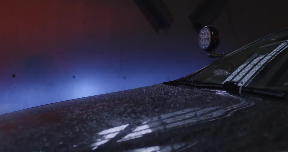 A cop car covered in water droplets