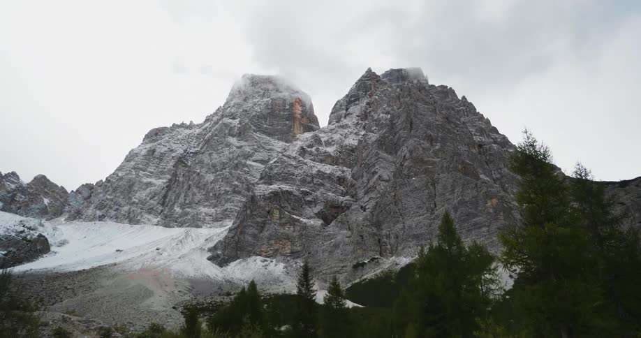 Clouds hover over mountain peaks