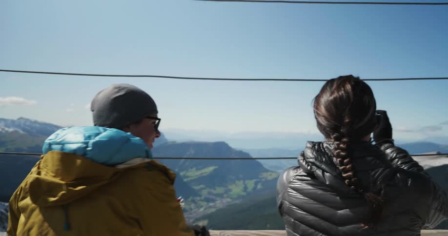 A couple of people looking out over the mountains