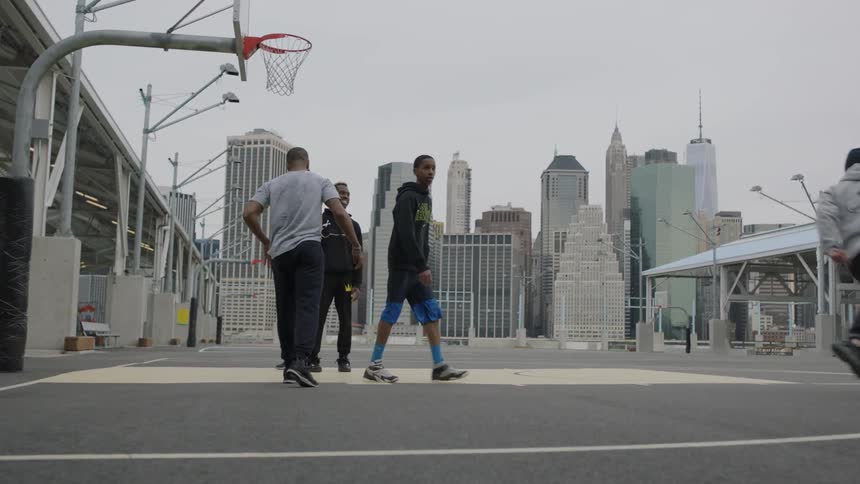 Group of young men playing basketball in the city