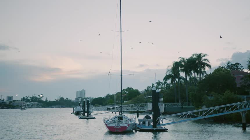Boats tied to docks at sunrise