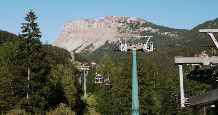 Ski lift traveling through trees