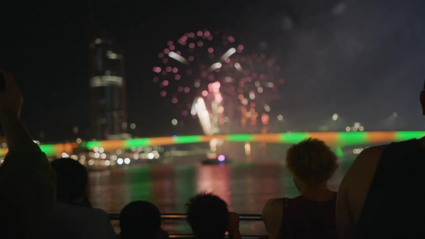 Fireworks explode in the air above water