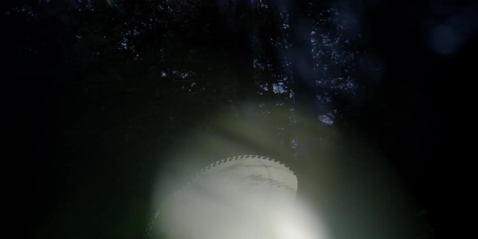 Light shining out of a tunnel in the woods at night