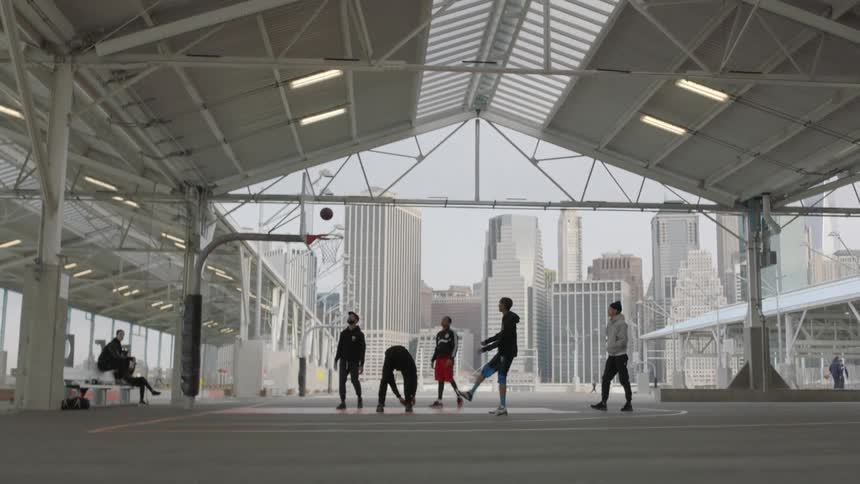 Group of men playing basketball in the city