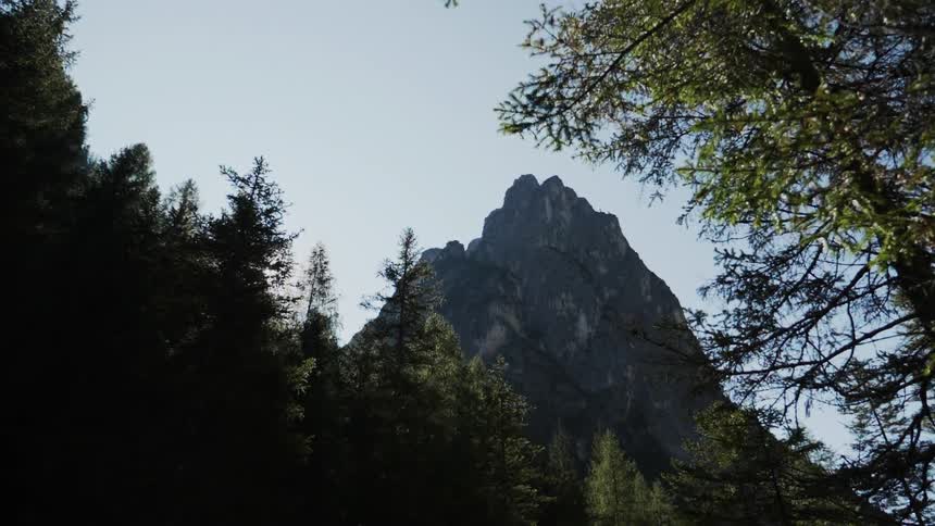 A stone mountain towers into the blue sky