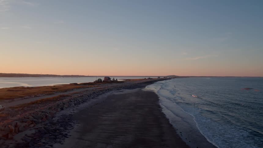 Waves splashing to shore at sunset