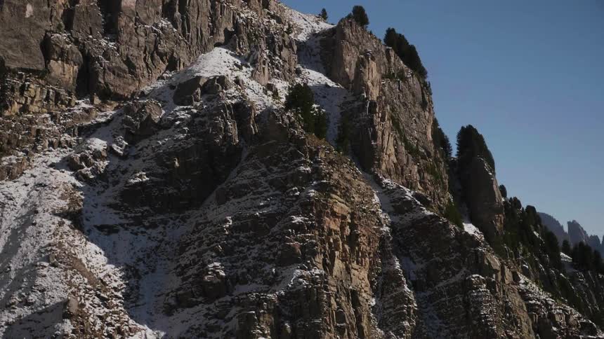 View of a rocky mountainside with snow on it