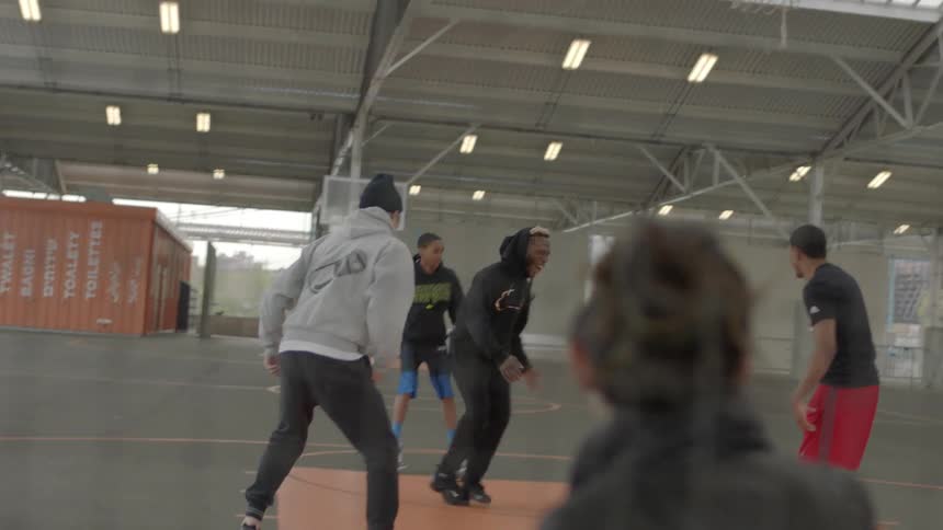 People play basketball on the court