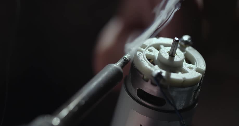 Smoke rises from an electrical component as solder is applied to it