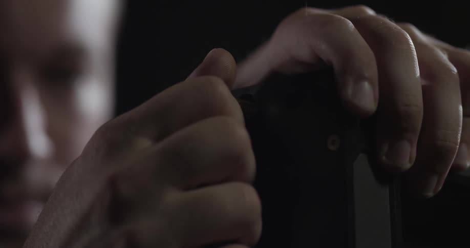 A man adjusts a knob on a piece of equipment