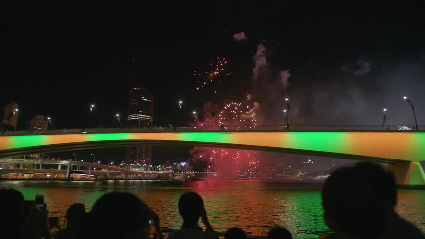 Fireworks explode in the air above water