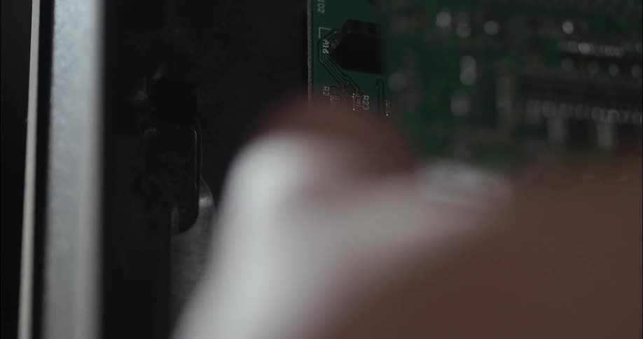 Close up of person fixing a computer