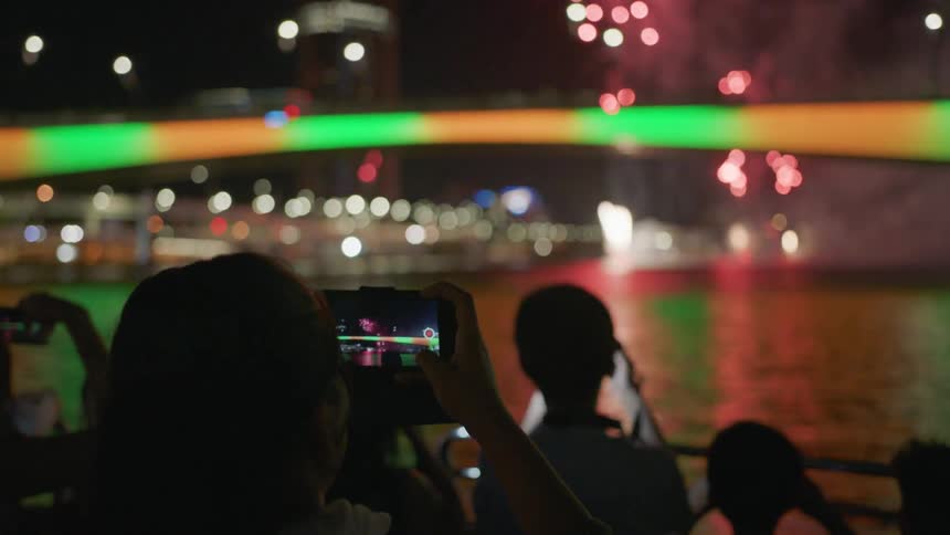 A group of people recording fireworks