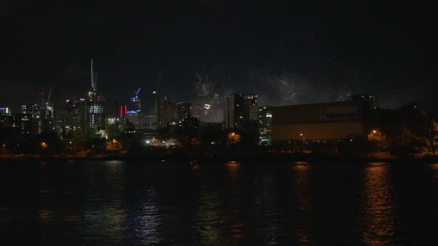 Fireworks shining in the middle of a city at night