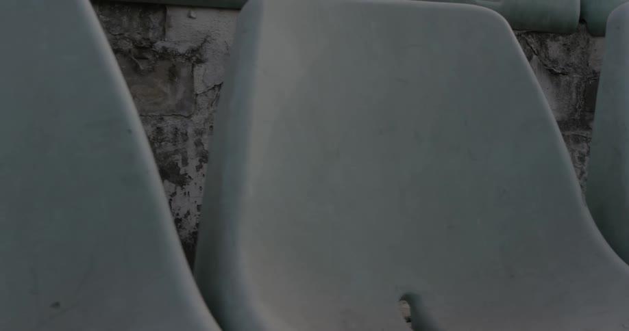 A pair of red boxing gloves sits on a white outdoor seat
