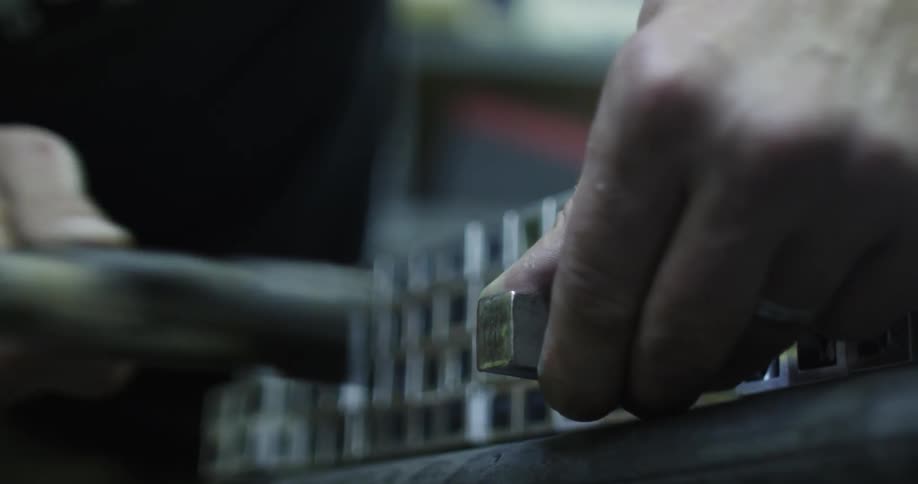 Person pounding metal into an object with a hammer