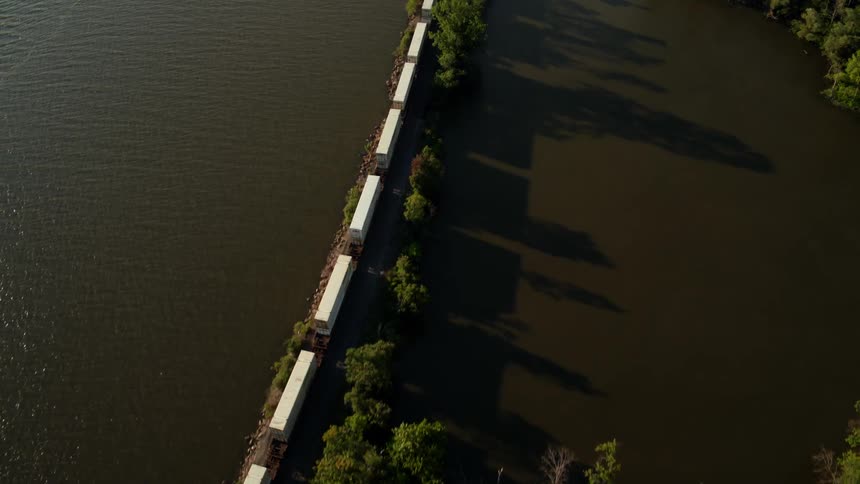 A train travels on the tracks above water