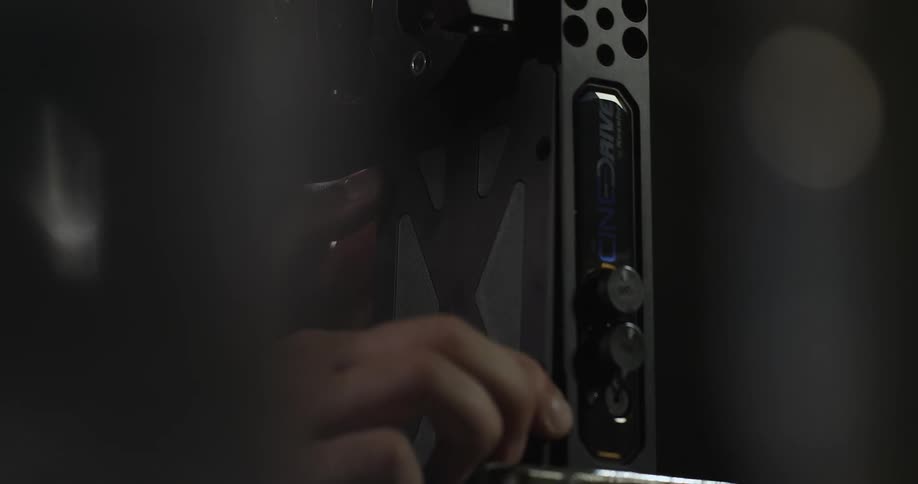 A person covers electrical parts with a metal lid