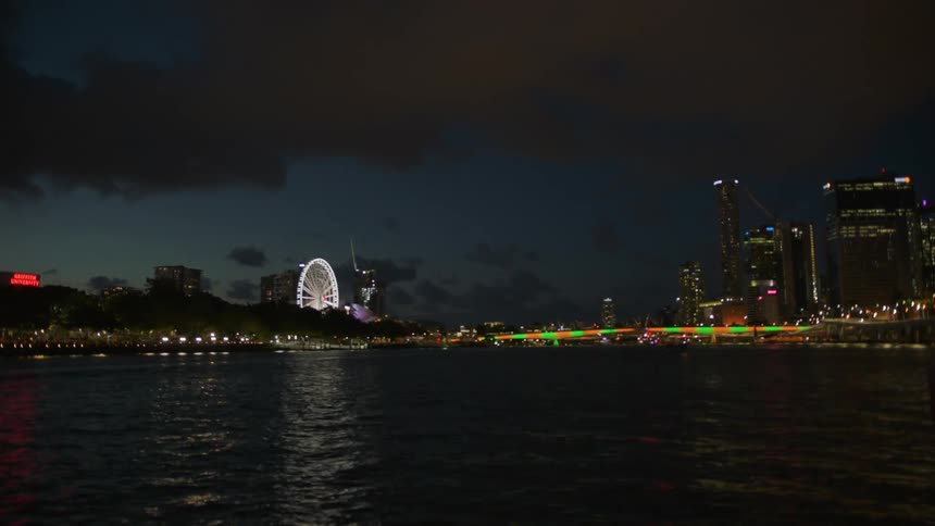 Body of water in front of a lit up city at night