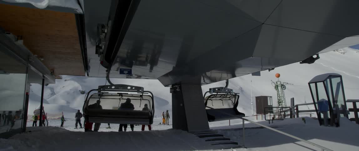 Ski lift at the top of a snowy hill