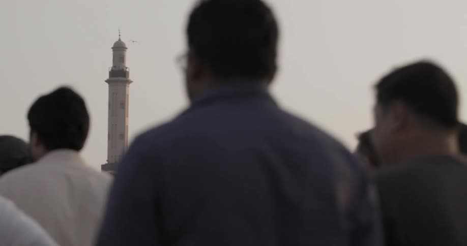 Pedestrians are travelling along a road in a middle eastern city