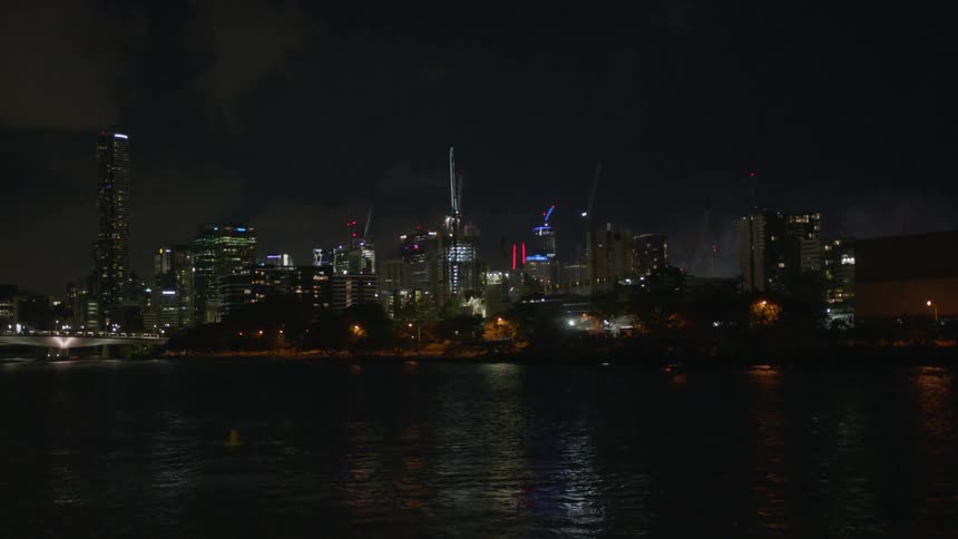Fireworks exploding in a city with tall skyscrapers