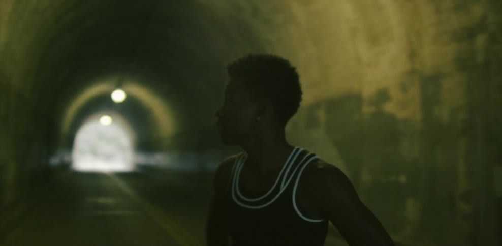 Woman stands in a tunnel looking around