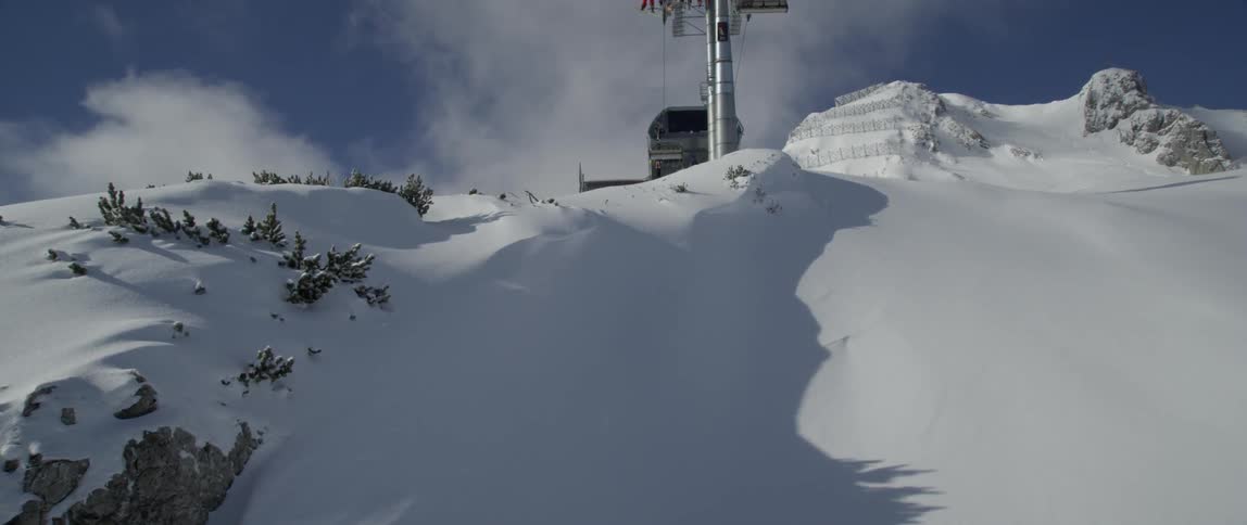 Ski lifts travel along the track above the mountain