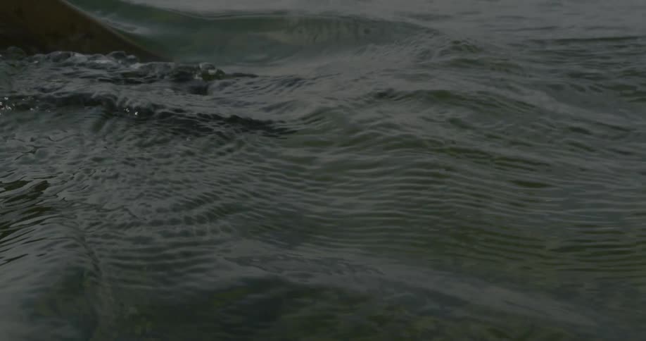 Oar splashes into wavy water