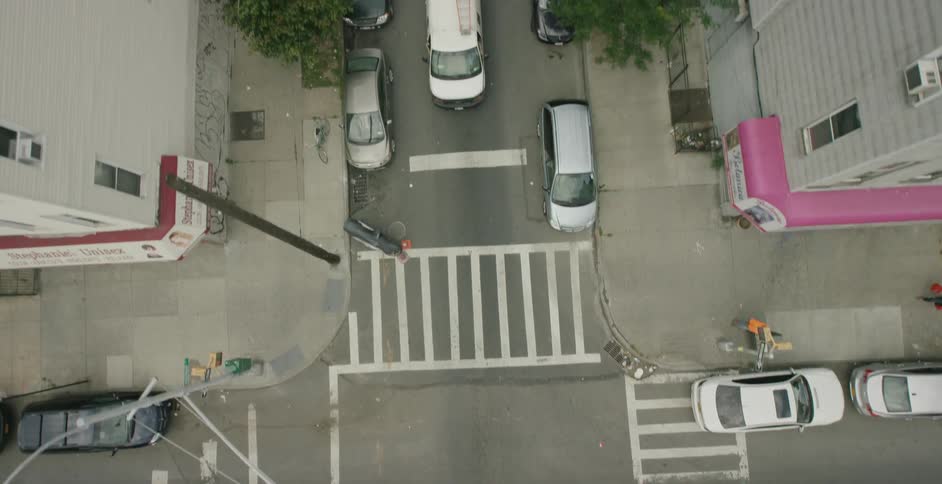 Overhead shot of urban area with cars, pedestrians, buildings, streets