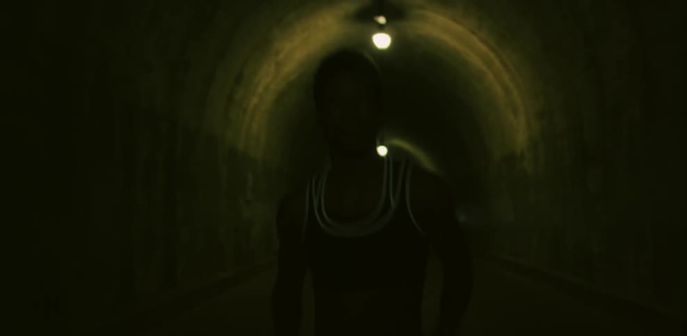 A woman is jogging in a tunnel