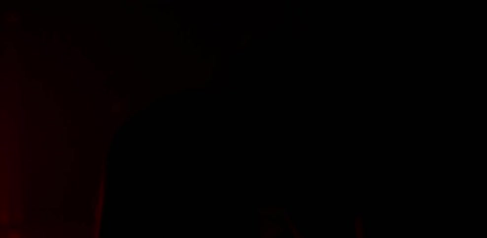 Couple kisses in a dim red room