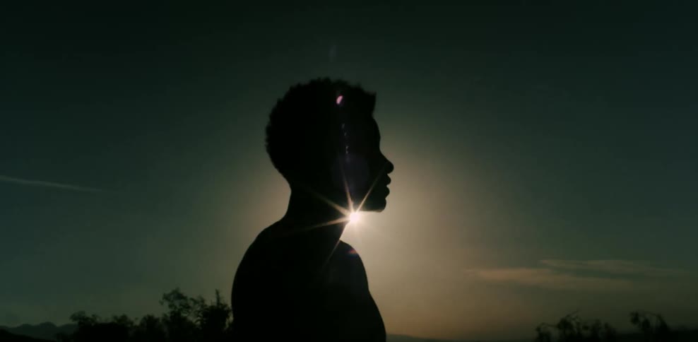A man stands outside in the sun