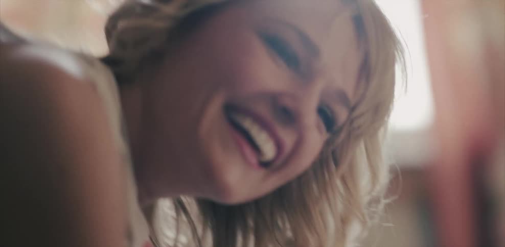 Woman laughing and smiling indoors on a sunny day