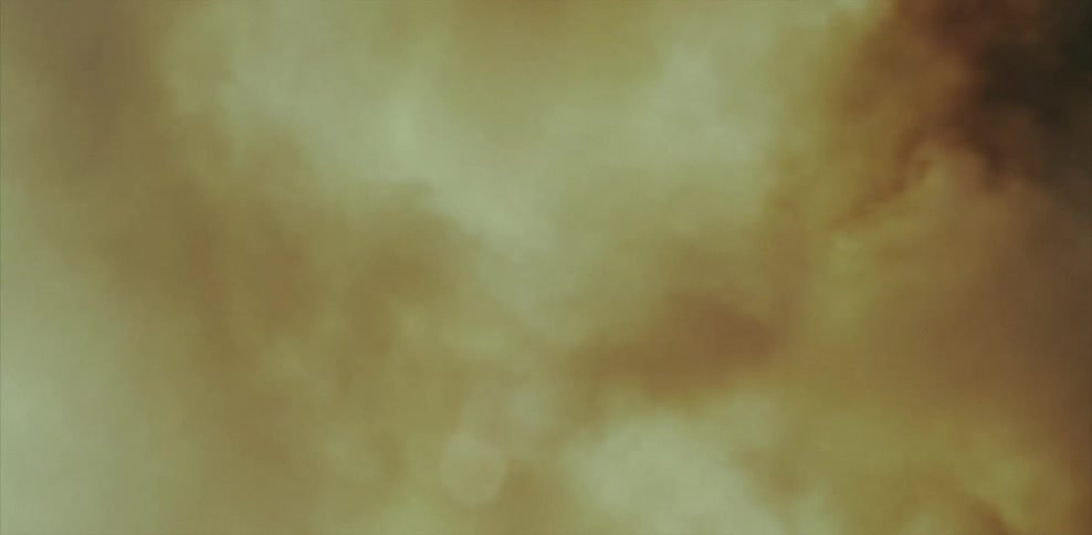 Smoke billowing in front of the sun