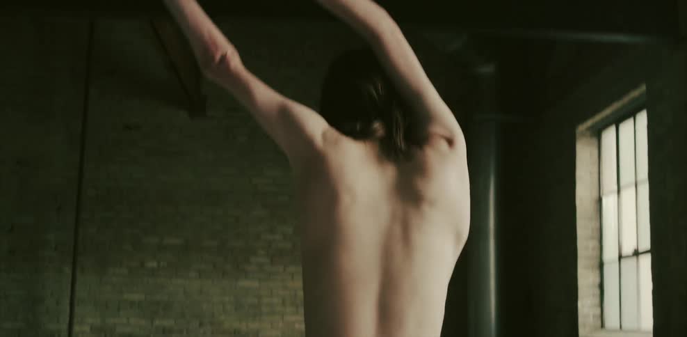 A double jointed man rotates his shoulders around his head