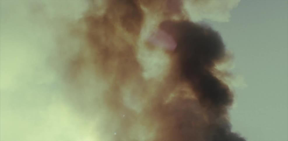Smoke billows into the air as a building burns