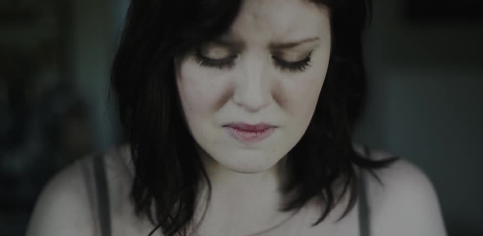 A woman cries and closes her eyes