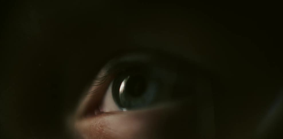 A person opens their eyes and looks around