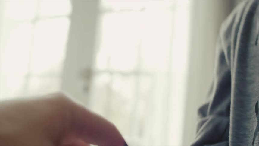 A girl kisses the bandaid on her parent's finger