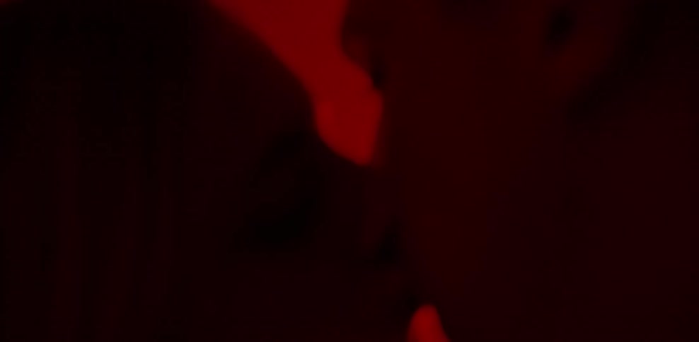 Man and woman making out in red light