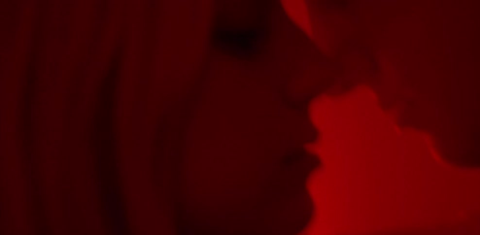 A man and woman hold their faces close together